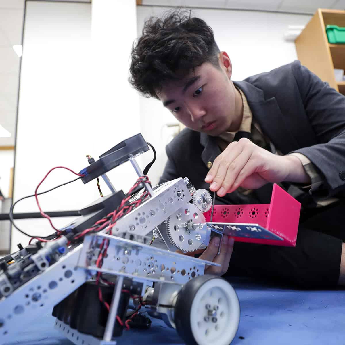 Student building a robot